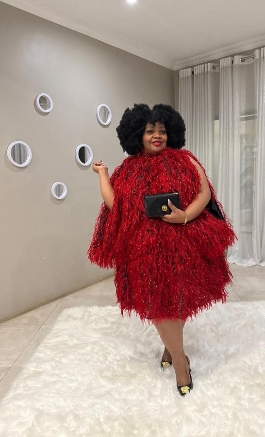 Alice in a red feathered dress